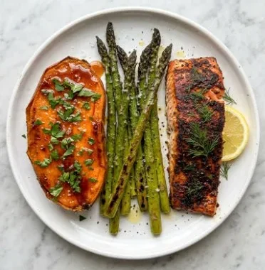 Baked salmon served with sweet potato and asparagus dish