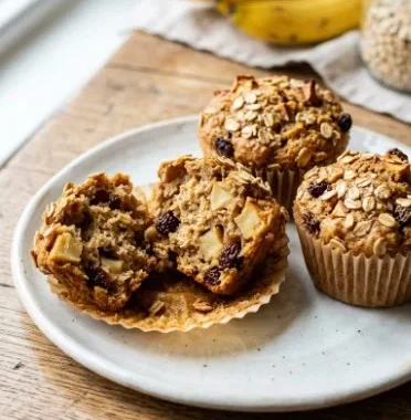 Healthy apple raisin oat mini muffins on a wooden table