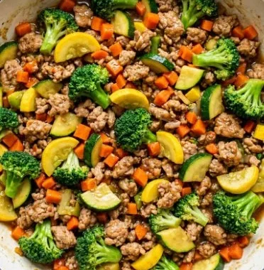 Healthy turkey stir fry with colorful vegetables in a pan