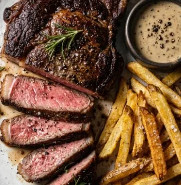 Delicious and crispy homemade steak fries served with dipping sauce.