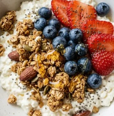 Cottage cheese breakfast bowl topped with fresh fruits