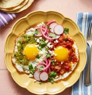 A plate of Divorced Eggs featuring separated yolks and sauces for flavor.
