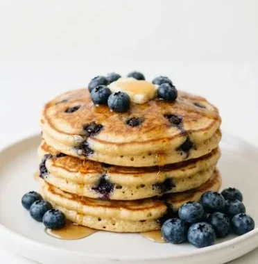 Easy vegan whole wheat blueberry pancakes on a plate