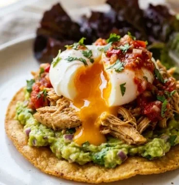 Delicious plate of Mexican Eggs Benedict with avocado and salsa