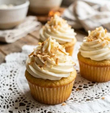 Delicious old fashioned coconut cupcakes topped with creamy frosting